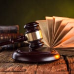 A former Burlington High School wrestling coach was convicted Wednesday on three counts of attempted transfer of obscene material to a minor.