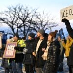 Protesters gather outside the Bishop Henry Whipple Federal Building in Minneapolis, Minn.