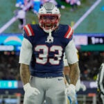 New England Patriots linebacker Anfernee Jennings (33) celebrates a tackle in the first half of an NFL wild-card playoff football game against the Los Angeles Chargers, in Foxborough, Mass., Sunday, Jan. 11, 2026.