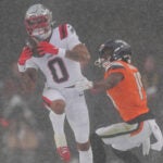 New England Patriots cornerback Christian Gonzalez intercepts a pass intended for Denver Broncos wide receiver Marvin Mims Jr. (19) during the second half of the AFC Championship NFL football game, Sunday, Jan. 25, 2026, in Denver.