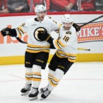 Boston Bruins center Elias Lindholm (28) celebrates his goal with center Pavel Zacha (18) during the third period of an NHL hockey game against the Washington Capitals, Wednesday, Oct. 8, 2025, in Washington.