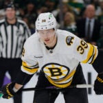 Boston Bruins center Morgan Geekie (39) lines up for a face-off during the first period of an NHL hockey game against the Minnesota Wild Sunday, Dec. 14, 2025, in St. Paul, Minn.