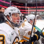Boston Bruins defenseman Charlie McAvoy watches from the bench during the third period of an NHL hockey game against the Dallas Stars, Tuesday, Jan. 20, 2026, in Dallas.