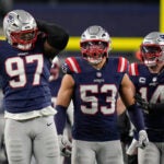 New England Patriots defensive end Milton Williams (97), linebacker Christian Elliss (53) and linebacker Robert Spillane (14) celebrate Williams' sack of Los Angeles Chargers quarterback Justin Herbert (10) in the second half of an NFL wild-card playoff football game in Foxborough, Mass., Sunday, Jan. 11, 2026.