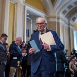 Senate Minority Leader Chuck Schumer, D-N.Y., waits to speak to reporters.