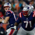New England Patriots quarterback Drake Maye (10) prepares to make a pass under pressure during the first half of an NFL football game against the Miami Dolphins, Sunday, Jan. 4, 2026, in Foxborough, Mass.