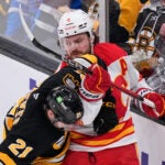 Calgary Flames defenseman Rasmus Andersson (4) tangles with Boston Bruins center Alex Steeves (21) during the first period of an NHL hockey game, Thursday, Jan. 8, 2026, in Boston.
