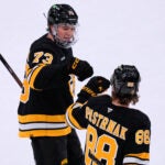 Boston Bruins defenseman Charlie McAvoy (73) is congratulated by David Pastrnak (88) after scoring against the Vegas Golden Knights during the first period of an NHL hockey game, Thursday, Jan. 22, 2026, in Boston.