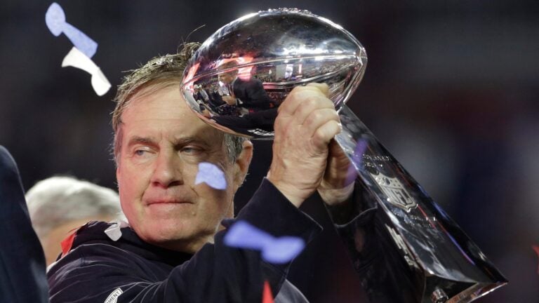 New England Patriots head coach Bill Belichick holds up the Vince Lombardi Trophy as he celebrates after the Patriots defeated the Seattle Seahawks 28-24 in NFL Super Bowl XLIX football game Sunday, Feb. 1, 2015, in Glendale, Ariz.