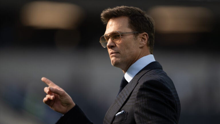 Tom Brady walks on the field before an NFL football game between the Los Angeles Rams and the Detroit Lions, Sunday, Dec. 14, 2025, in Inglewood, Calif.