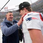 New England Patriots head coach Mike Vrabel speaks with quarterback Drake Maye after the AFC Championship NFL football game against the Denver Broncos, Sunday, Jan. 25, 2026, in Denver.