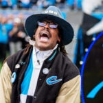 Former Carolina Panthers player Cam Newton beats on a drum before an NFL wild-card playoff football game between the Carolina Panthers and the Los Angeles Rams on Saturday, Jan. 10, 2026, in Charlotte, N.C.
