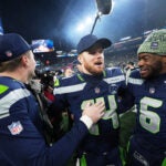 Seattle Seahawks quarterback Sam Darnold, center, celebrates with quarterback Jalen Milroe (6) quarterback Drew Lock, left, after the NFC Championship NFL football game Sunday, Jan. 25, 2026, in Seattle.