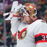 Ottawa Senators goaltender Linus Ullmark adjusts his helmet during the first period of an NHL hockey game against the Dallas Stars, Sunday, Nov. 30, 2025, in Dallas.