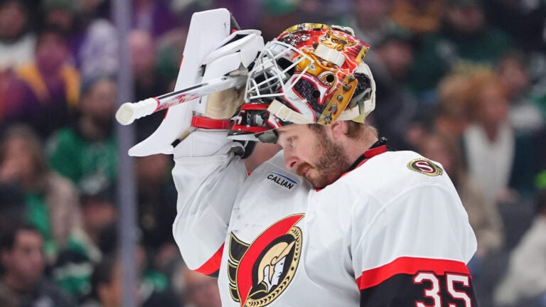 Ottawa Senators goaltender Linus Ullmark adjusts his helmet during the first period of an NHL hockey game against the Dallas Stars, Sunday, Nov. 30, 2025, in Dallas.