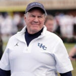 North Carolina head coach Bill Belichick smiles as he walks the sidelines before an NCAA college football game against Stanford, Saturday, Nov. 8, 2025, in Chapel Hill, N.C. (AP Photo/Chris Seward)