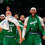 Dallas Mavericks' Klay Thompson (31) and Daniel Gafford, right, and the rest of the bench celebrate in the second half of an NBA basketball game against the Phoenix Suns Wednesday,Nov. 12, 2025, in Dallas.