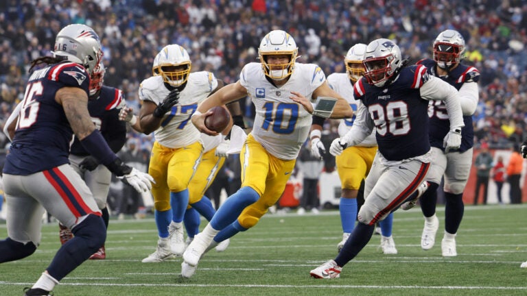 Los Angeles Chargers quarterback Justin Herbert (10) rushes against the New England Patriots during the fourth quarter at Gillette Stadium.