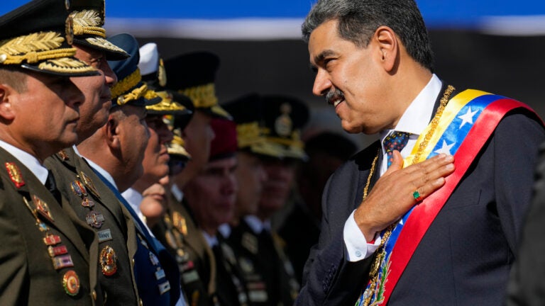 Venezuela's President Nicolas Maduro places his hand over his heart while talking to high-ranking officers during a military ceremony on his inauguration day for a third term, in Caracas, Venezuela.