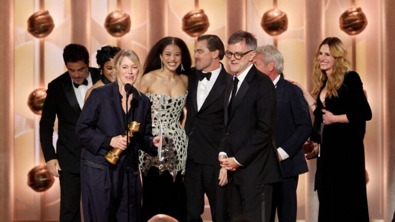 Sara Murphy, foreground left, appearing with writer-director Paul Thomas Anderson, foreground right, and other cast members, as well as presenter Julia Roberts, right, as they accept the award for best motion picture - musical or comedy for "One Battle After Another" during the 83rd Golden Globes on Sunday, Jan. 11, 2026, at the Beverly Hilton in Beverly Hills, Calif.