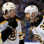 Charlie McAvoy #73 and Zdeno Chara #33 of the Boston Bruins talk during Game Two of the Eastern Conference Second Round against the Tampa Bay Lightning during the 2018 NHL Stanley Cup Playoffs at Amalie Arena on April 30, 2018 in Tampa, Florida.