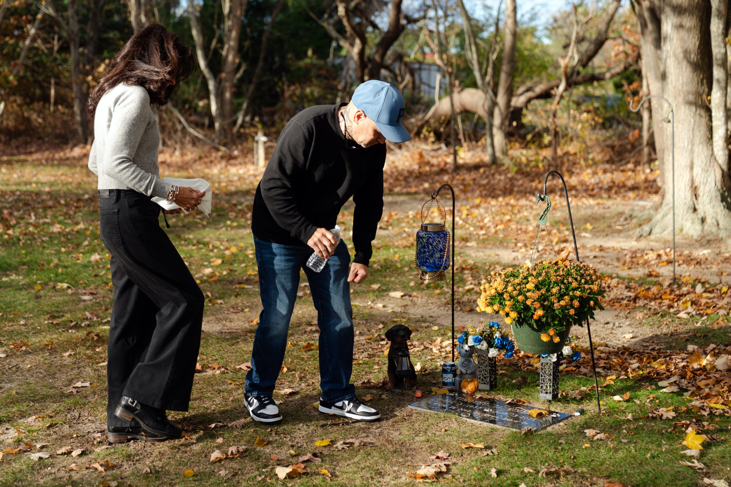 Angela and Timothy Kimball place flowers on the grave of their son, TJ Kimball, in Plymouth, Mass.
