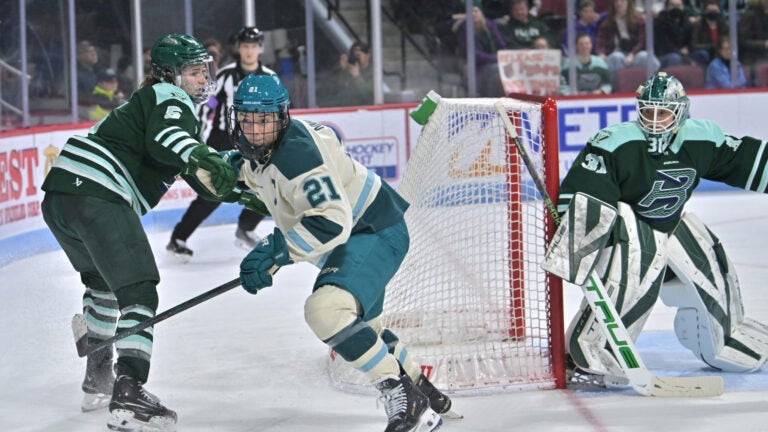 Former Fleet player Hilary Knight (21), center, of the Seattle Torrent, and, from left, US Olympians, Megan Keller (5) Goalie Aerin Frankel (31), of the Fleet net at the Agganis Arena on Jan. 7 2026.