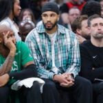 Boston Celtics bench (l to r) Xavier Tillman Sr., Jason Tatum, D.J. MacLeay (assistant coach) as they fall behind by 25 points against the Houston Rockets during third quarter action at TD Garden on Saturday November 1, 2025.