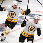 Bruins Alex Steeves (left) celebrates a 2nd period goal by Fraser Minten(rt).