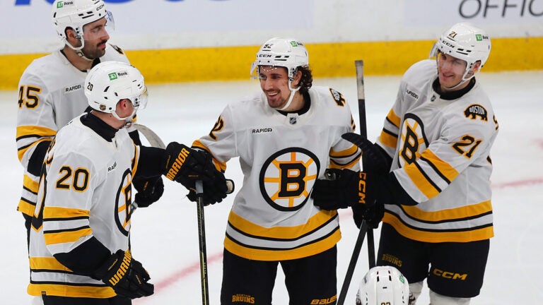 Bruins Bruins Henri Jokiharju(left) and Alex Steeves(right) congratulate Marat Khusnutdinov (c) after Marat scored his 4th goalcoming in the 3rd period.