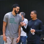 The Boston Celtics held their first day of training camp at the Auerbach center on Tuesday. Jayson Tatum(left) chats with coach Joe Mazzulla on the court.