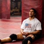 Dwayne Johnson as Mark Kerr, exhausted after a fight, in “The Smashing Machine.”