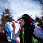 Sydney Stephenson of Pittsburgh blows bubbles outside the Supreme Court.