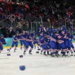 MILAN, ITALY - FEBRUARY 19: Megan Keller #5 of Team United States celebrates with teammates after scoring the game-winning goal to win the gold medals in the overtime during the Women's Gold Medal match between the United States and Canada on day 13 of the Milano Cortina 2026 Winter Olympic games at Milano Santagiulia Ice Hockey Arena on February 19, 2026 in Milan, Italy.