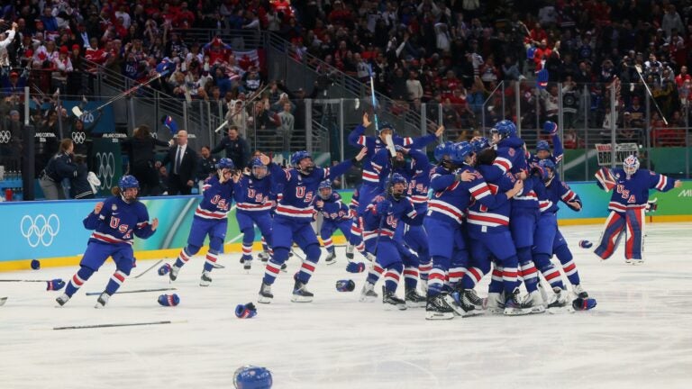 MILAN, ITALY - FEBRUARY 19: Megan Keller #5 of Team United States celebrates with teammates after scoring the game-winning goal to win the gold medals in the overtime during the Women's Gold Medal match between the United States and Canada on day 13 of the Milano Cortina 2026 Winter Olympic games at Milano Santagiulia Ice Hockey Arena on February 19, 2026 in Milan, Italy.