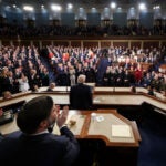 Members of the Congress give a standing ovation as President Donald Trump delivers the State of the Union address.