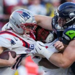 Seattle Seahawks defensive end Rylie Mills, right, sacks New England Patriots quarterback Drake Maye, left, during the first half of the NFL Super Bowl 60 football game, Sunday, Feb. 8, 2026, in Santa Clara, Calif.