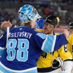 Tampa Bay Lightning goaltender Andrei Vasilevskiy (88) hugs Boston Bruins right wing David Pastrnak after the Lightning defeated the Bruins during a shootout in a Stadium Series NHL hockey game Sunday, Feb. 1, 2026, in Tampa, Fla.