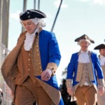 Boston Bruins players, wearing revolutionary war attire, arrive at the stadium before a Stadium Series NHL hockey game against the Tampa Bay Lightning Sunday, Feb. 1, 2026, in Tampa, Fla.
