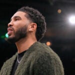 Boston Celtics forward Jayson Tatum stands next to the bench during a time out in the first half of an NBA basketball game against the Chicago Bulls, Wednesday, Feb. 11, 2026, in Boston.