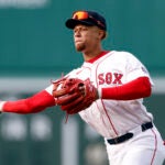 Boston Red Sox second baseman Kristian Campbell (28) throws to first for an out during the third inning at Fenway Park.