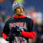 New England Patriots cornerback Christian Gonzalez (0) wears a Donna Summer shirt during warmups. The New England Patriots played the New York Giants at Gillette Stadium on December 1, 2025.
