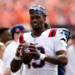 New England Patriots quarterback Joe Milton III (19) throws the ball on the sideline during the NFL season opener at Paycor Stadium.