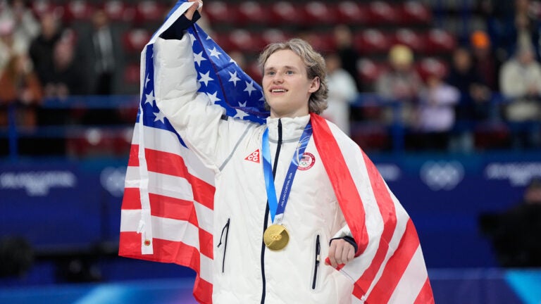 Team USA's Ilia Malinin celebrates with his gold medal after the figure skating team event at the 2026 Winter Olympics.