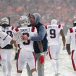 New England Patriots head coach Mike Vrabel hugs New England Patriots cornerback Christian Gonzalez (0) after Gonzalez intercepted a pass during the fourth quarter. The New England Patriots played the Denver Broncos in the AFC Championship football game at Empower Field at Mile High on Sunday, January 25, 2026.