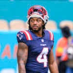 New England Patriots running back Antonio Gibson (4) stands on the field before an NFL football game against the Miami Dolphins, Saturday, Sept. 14, 2025, in Miami Gardens, Fla.