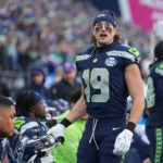 Seattle Seahawks wide receiver Jake Bobo (19) looks on from the bench before the NFC Championship NFL football game against the Los Angeles Rams, Sunday, Jan. 25, 2026, in Seattle.