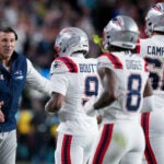 New England Patriots head coach Mike Vrabel celebrates with members of his team after a touchdown during the second half of the NFL Super Bowl 60 football game against the Seattle Seahawks, Sunday, Feb. 8, 2026, in Santa Clara, Calif.