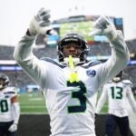 CHARLOTTE, NORTH CAROLINA - DECEMBER 28: Nick Emmanwori #3 reacts after Julian Love #20 of the Seattle Seahawks intercepted a pass during the third quarter against the Carolina Panthers at Bank of America Stadium on December 28, 2025 in Charlotte, North Carolina.