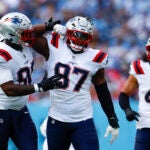 New England Patriots defensive end Milton Williams (97) celebrates a sack with defensive tackle Christian Barmore (90) during the third quarter at Nissan Stadium on Oct. 19, 2025.